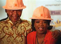 Nelson Mandela and Oprah Winfrey in hard hats