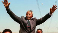 Nelson Mandela waving open hands to cheering crowd