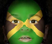 Flag face. Jamaican flag painted on face of child.