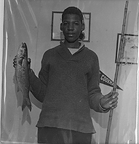 Lawrence holding Fish caught with flimsy pole
